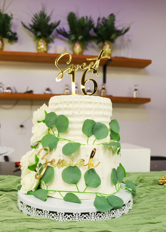 White and green cake with a gold Sweet 16 topper