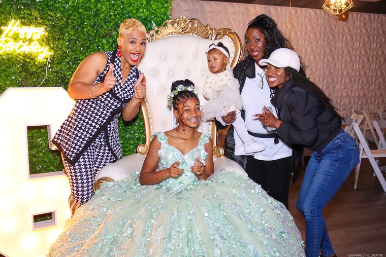 Sweet 16 celebrant sharing a playful family group portrait